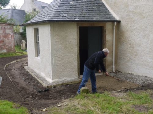 raking the path at the East Church, Cromarty
